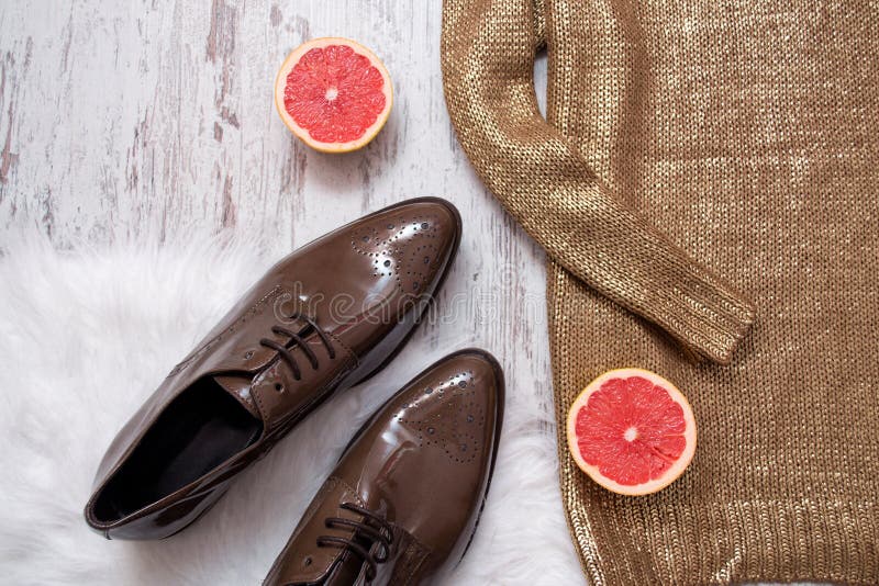 Part of a Golden Sweater, Brown Patent Leather Shoes and Grapefruit ...