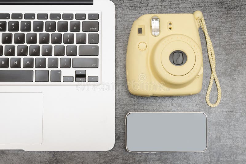 Part of the Laptop Keyboard, a Yellow Camera and a Smartphone. T Stock