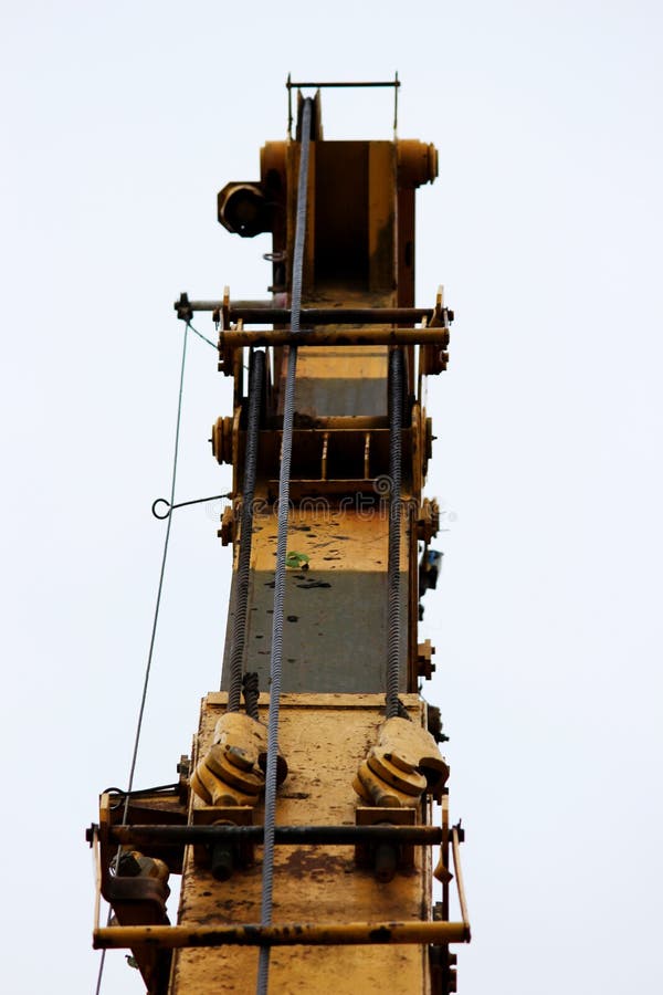 Part of Old Working Yellow Crane Truck for Construction on a Blue Sky. Stock Image Image of