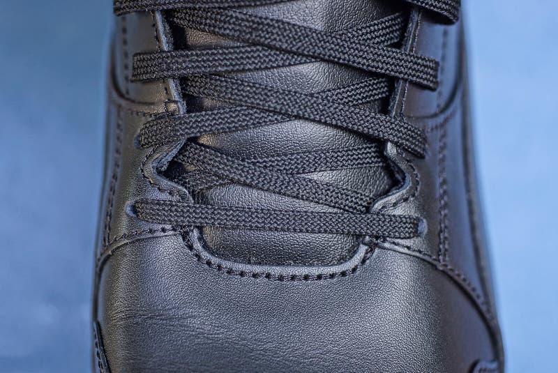 Part of one big black leather sneaker royalty free stock images
