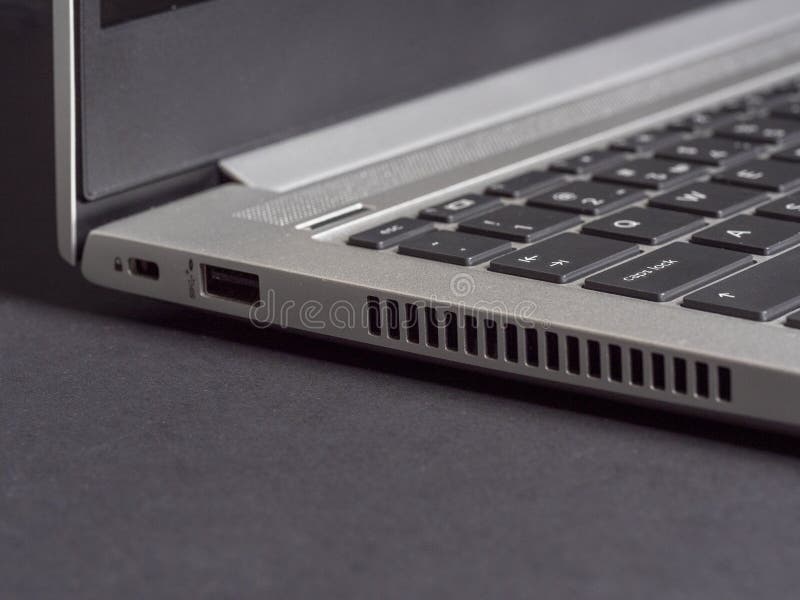 Part of the Open Laptop Made of Aluminum on a Gray Background. Side