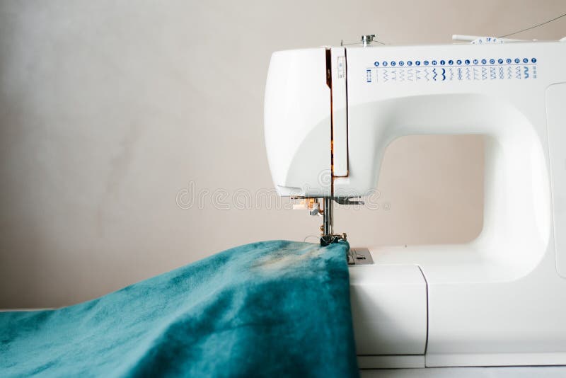 Sewing Machine with a Needle and a Thread Pulled into it and a Fabric