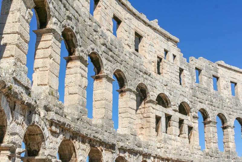 Arched Windows Of An Ancient Roman Amphitheater Against Arched Windows Of An Ancient Roman Amphitheater Against