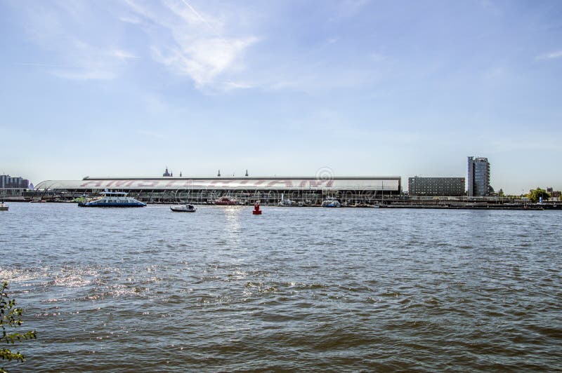 Parte traseira da estação central com uma balsa em Amsterdão o 2018 holandês imagem de stock Parte traseira da estação central com uma balsa em Amsterdão o 2018 holandês imagem de stock