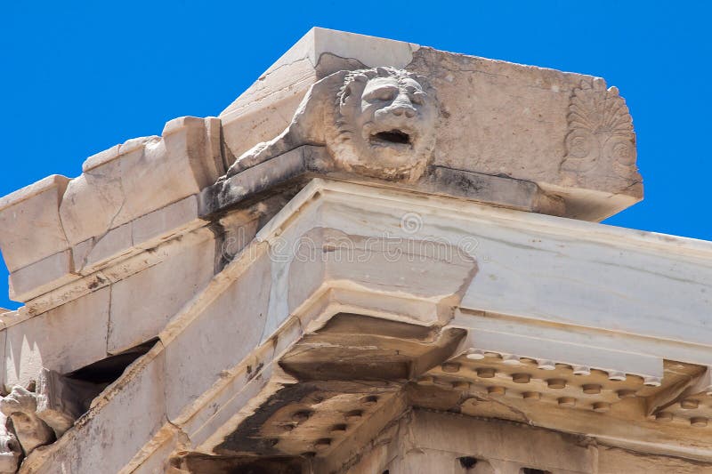 Detail of the top of the Parthenon in the Acropolis of Athens ancient greek temple, a lion head used to spit rain water. Detail of the top of the Parthenon in the Acropolis of Athens ancient greek temple, a lion head used to spit rain water.