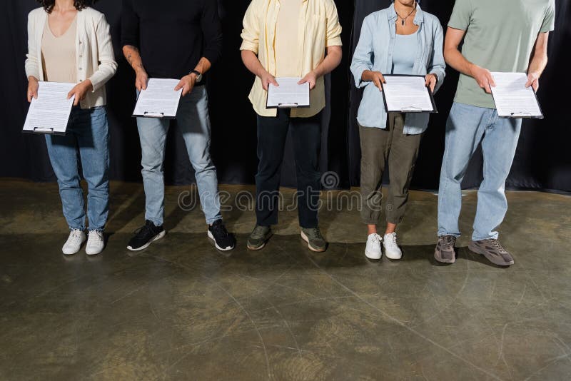 Partial view of multiethnic actors holding stock photo
