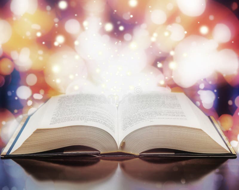 Open text book with magic light particles. Open text book with magic light particles.