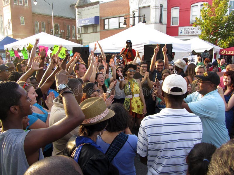 Photo of people dancing at the h street festival in downtown washington dc on 9/15/12. This festival takes place every year in mid september with food, arts and crafts, music, a parade, car displays, free health screenings and dance. The h street neighborhood is undergoing revitalization. Photo of people dancing at the h street festival in downtown washington dc on 9/15/12. This festival takes place every year in mid september with food, arts and crafts, music, a parade, car displays, free health screenings and dance. The h street neighborhood is undergoing revitalization.