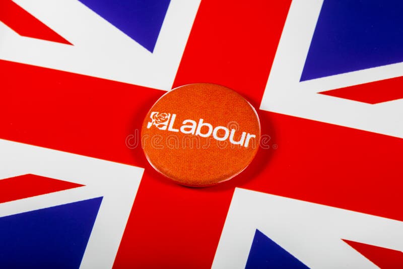 LONDON, UK - MAY 2ND 2017: A Labour Party pin badge over the UK flag, on 2nd May 2017. LONDON, UK - MAY 2ND 2017: A Labour Party pin badge over the UK flag, on 2nd May 2017.