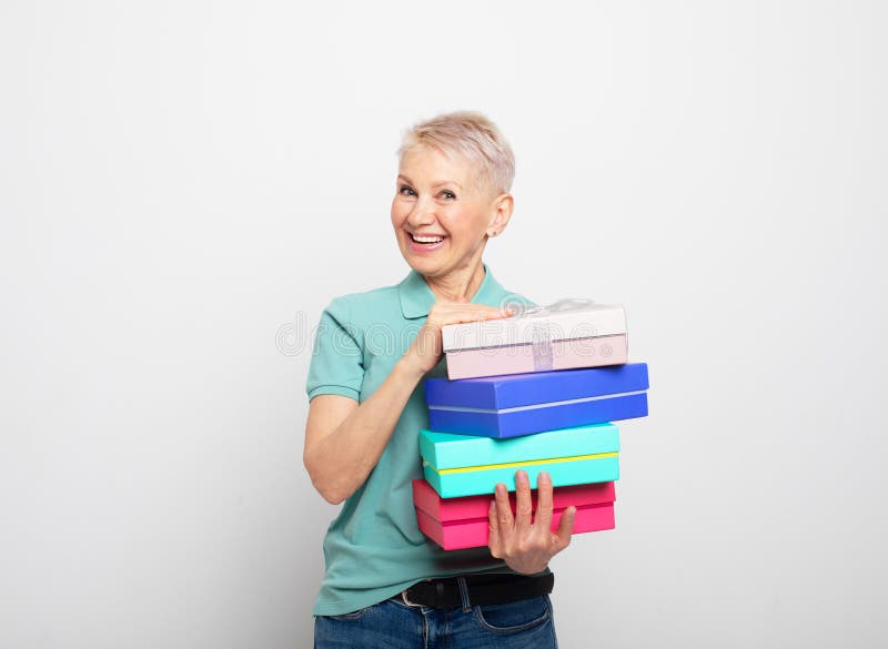 Smiling Elderly Woman Holding A Birthday Gift Isolated Stock Photo