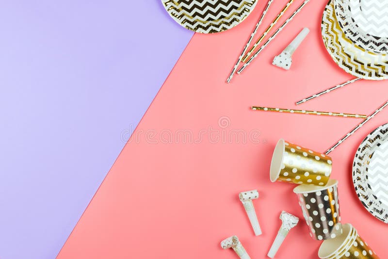 Party golden and silver paper glasses, dishes and straws on a table. royalty free stock images Party golden and silver paper glasses, dishes and straws on a table. royalty free stock images
