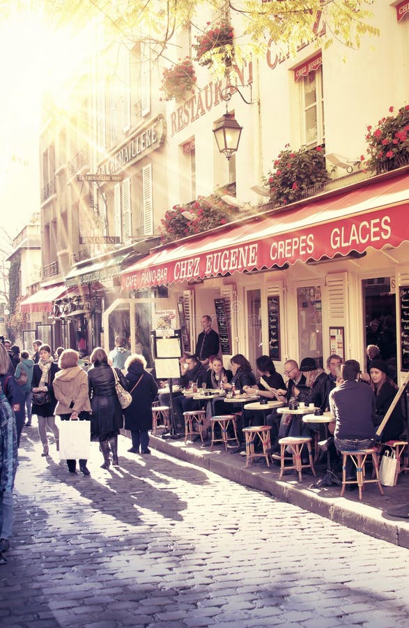 Street in paris with cafe and parisians enjoying the sunny day. Street in paris with cafe and parisians enjoying the sunny day