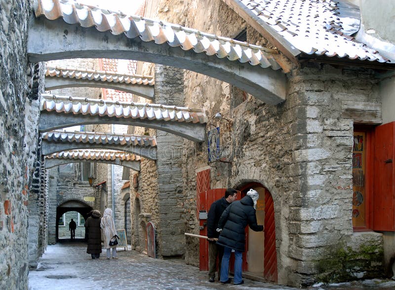 St Catherine`s Passage in Tallinn Old Town with its cobbled street and archways. People shopping in one of the most picturesque locations in Tallinn, Estonia. St Catherine`s Passage in Tallinn Old Town with its cobbled street and archways. People shopping in one of the most picturesque locations in Tallinn, Estonia