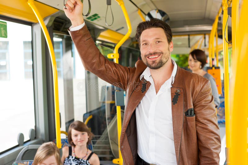 Male passenger in a bus; presumably he is heading home. Male passenger in a bus; presumably he is heading home