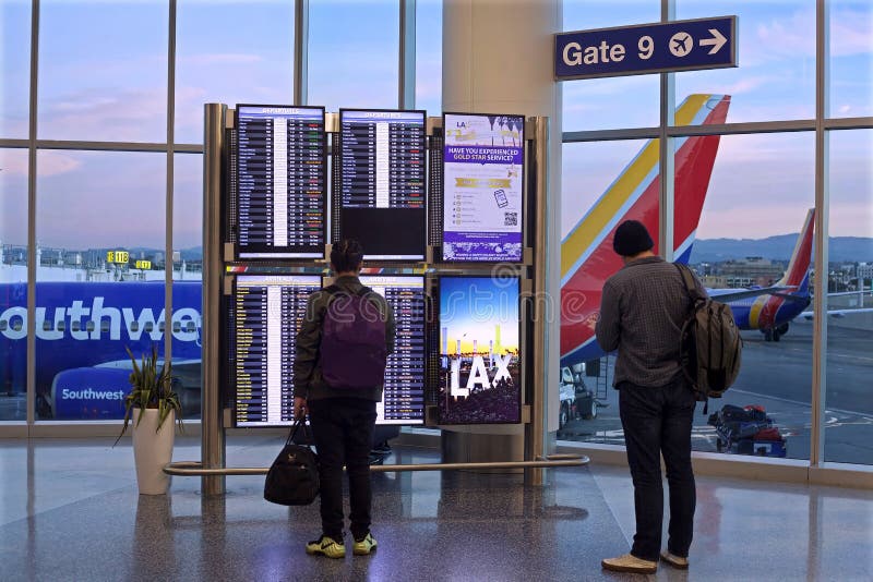 Southwest Airlines passengers watch information display at departure gate in Los Angeles. Southwest Airlines passengers watch information display at departure gate in Los Angeles