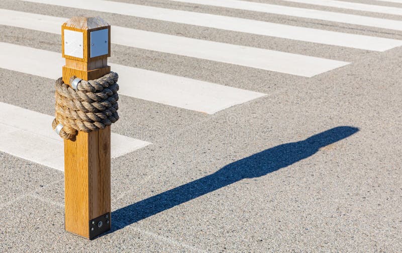 Zebra Crossing, Low Angle View, wooden bollard with traffic zebra. Street view, selective focus, nobody, copy space for text. Zebra Crossing, Low Angle View, wooden bollard with traffic zebra. Street view, selective focus, nobody, copy space for text