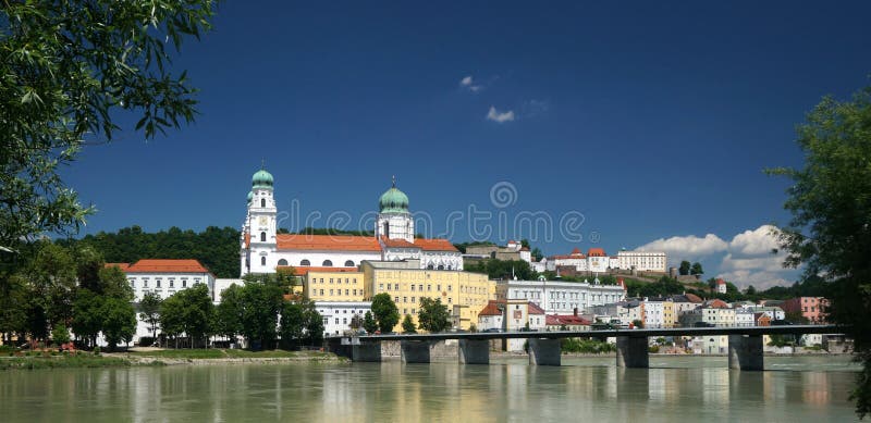 Passau, a city in Lower Bavaria, Germany, is also known as the City of Three Rivers, because the Danube is joined at Passau by the Inn from the south (the picture shows the Inn River in front) and the Ilz from the north. Passaus population is approximately 50,000, of whom about 11,000 are students at the local Passau University. The school was founded in the late 1970s. Its roots go back to the Institute for Catholic Studies founded in 1622. It is renowned in Germany for its institutes of economics, law, theology, computer sciences and Cultural Studies. Passau once was an ancient Roman colony. During the second half of the 5th century, St. Severinus established a monastery here. In 739, an English monk called Boniface founded the diocese of Passau. At the time it was the largest diocese of the Holy Roman Empire for many years. In the Treaty of Passau (1552), Archduke Ferdinand I, representing Emperor Charles V, secured the agreement of the Protestant princes to submit the religious question to a diet. This led to the Peace of Augsburg in 1555. From 1892 until 1894, Adolf Hitler and his family lived in Passau.