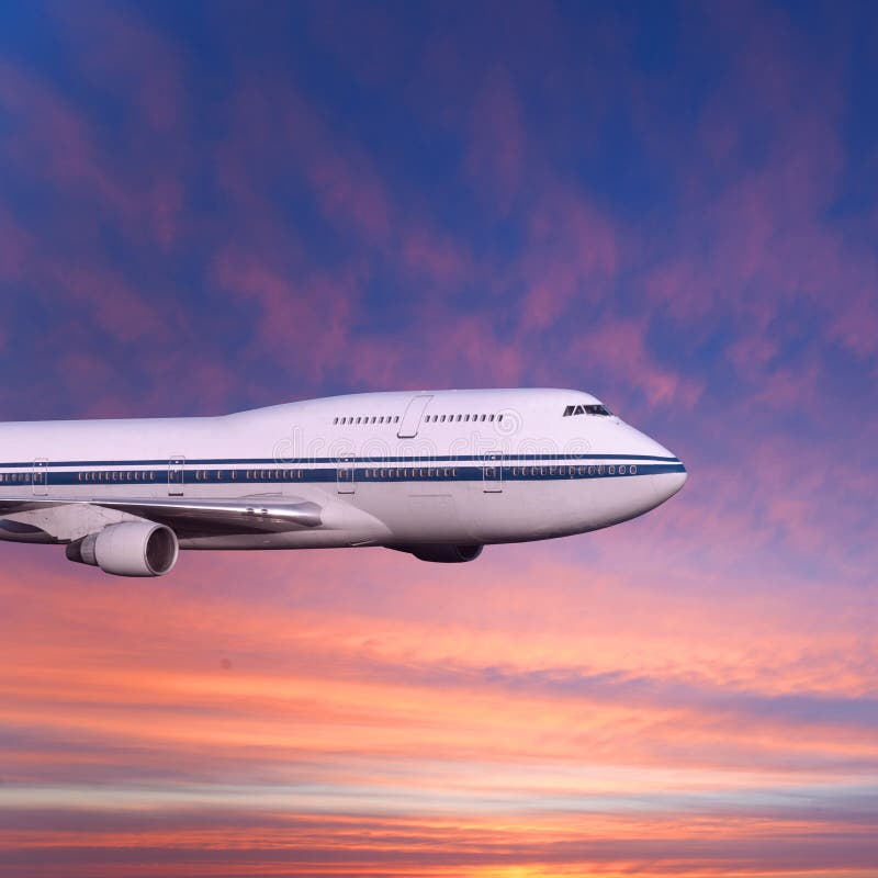 Passenger airplane in the clouds at sunset or dawn.