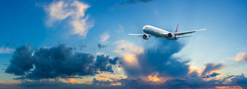 Passenger airplane flying above night clouds and amazing sky at the sunset. stock photo Passenger airplane flying above night clouds and amazing sky at the sunset. stock photo