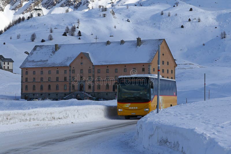 Passenger bus on snowy mountain pass top