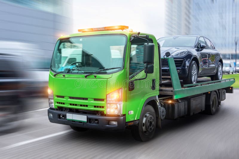 Passenger car loaded onto a tow truck for transportation, delivered to the destination. With motion blur speed effect