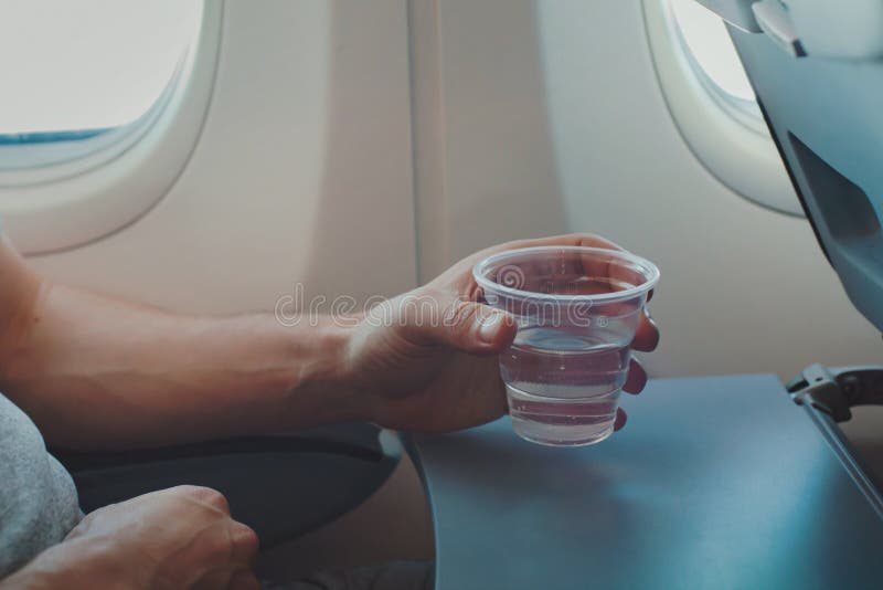 https://thumbs.dreamstime.com/b/passenger-drinking-water-airplane-flight-passenger-drinking-water-airplane-flight-close-up-hand-holding-211252846.jpg