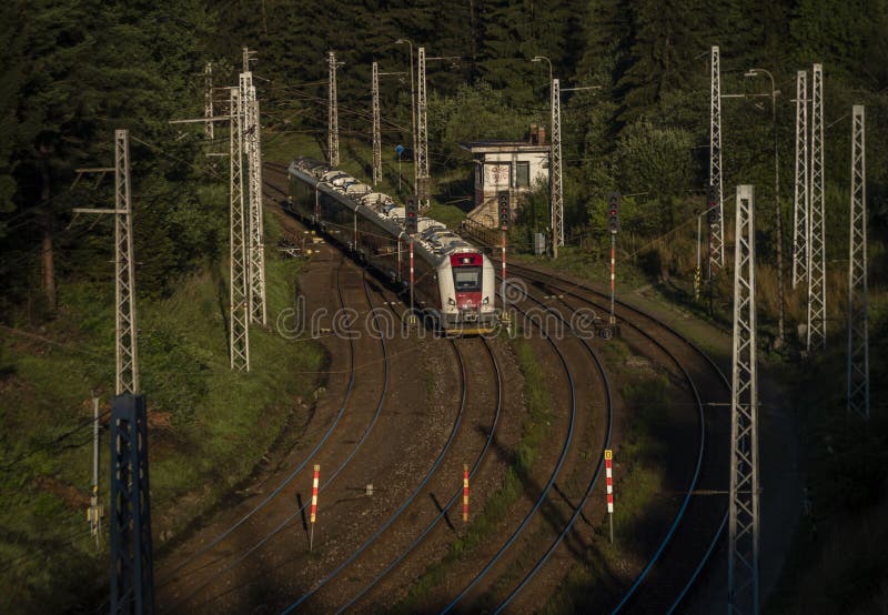 Passenger electric train coming to station Strba in Slovakia montains in morning