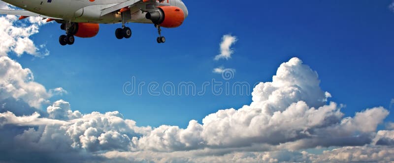 Passenger jet against a blue sky with white fluffy clouds