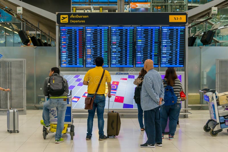 Passenger looking at the display time Departure board at .Suvarnabhumi Airport Thailand stock photos Passenger looking at the display time Departure board at .Suvarnabhumi Airport Thailand stock photos