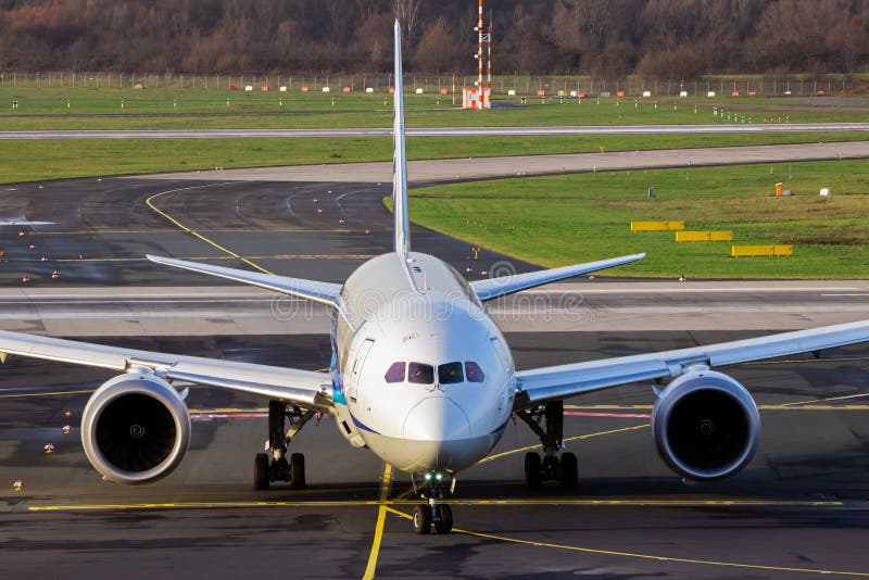 passenger plane arriving at an airport and taxiing to the terminal gate