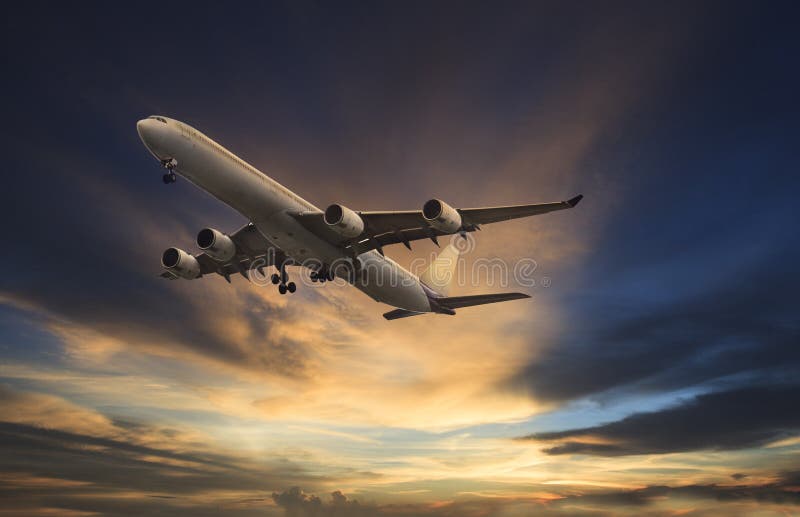Passenger plane flying on beautiful dusky sky stock photos Passenger plane flying on beautiful dusky sky stock photos