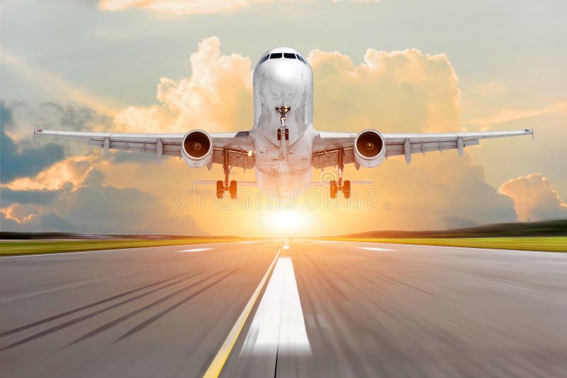 Passenger plane take off from the runway before the light from the sunshine.