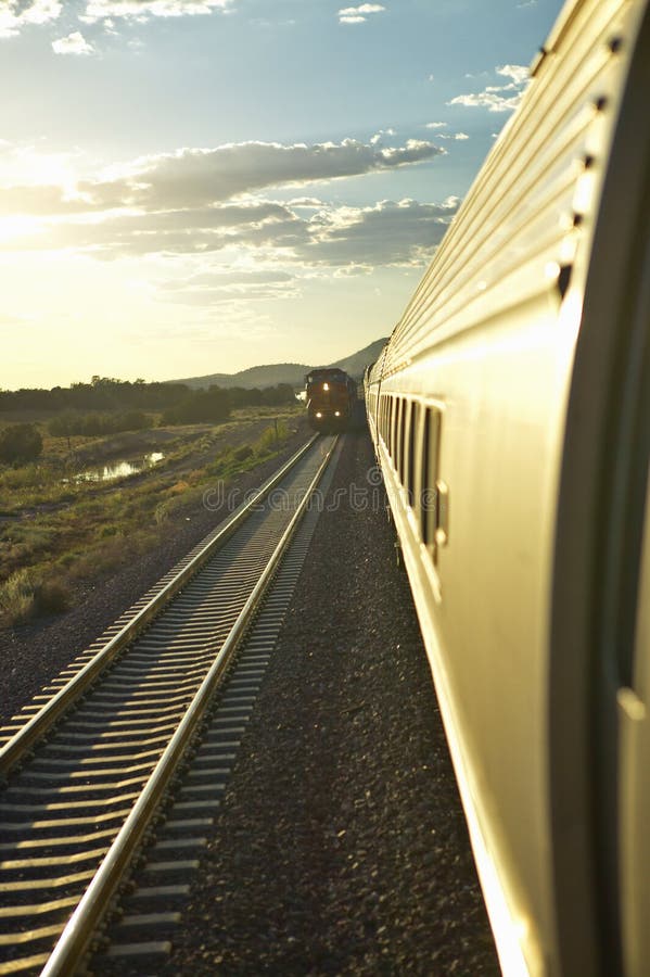 Passenger Train Traveling into the Arizona Sunset Editorial Photo