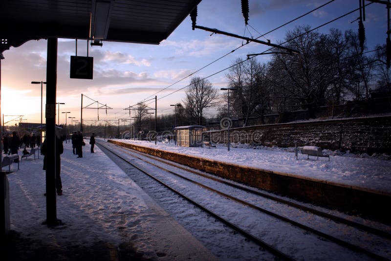 Passengers waiting on snow covered platform