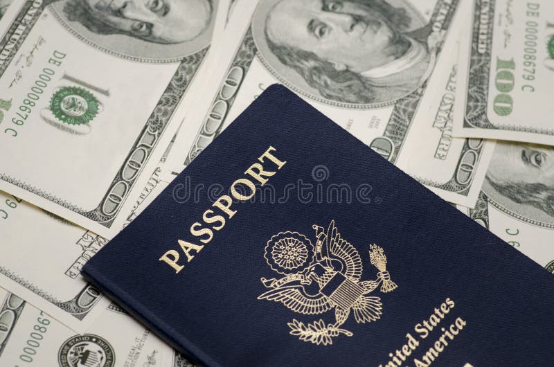 Close up photo of US Passport and pile of US dollar money. Close up photo of US Passport and pile of US dollar money