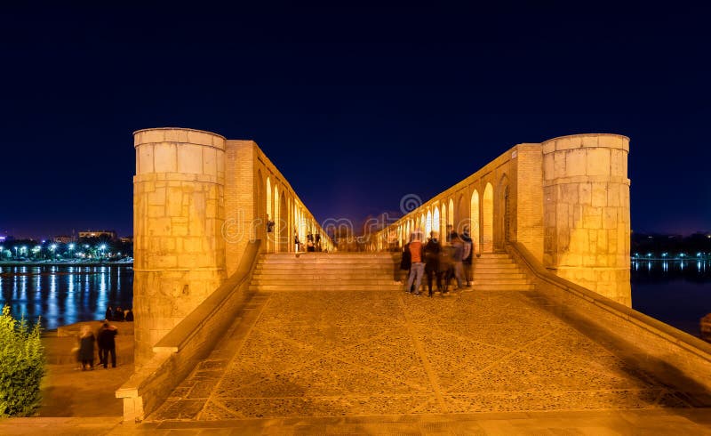 Walkway and arched walls on Si-o-Se Pol (Bridge of 33 Arches or Allahverdi Khan Bridge) at night on Zayanderud River in Isfahan, Iran. Architectural masterpiece and historical heritage. Walkway and arched walls on Si-o-Se Pol (Bridge of 33 Arches or Allahverdi Khan Bridge) at night on Zayanderud River in Isfahan, Iran. Architectural masterpiece and historical heritage.