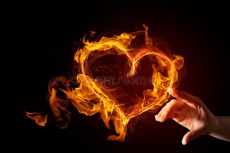 Hand touch glowing love hearts symbol on dark background. Hand touch glowing love hearts symbol on dark background