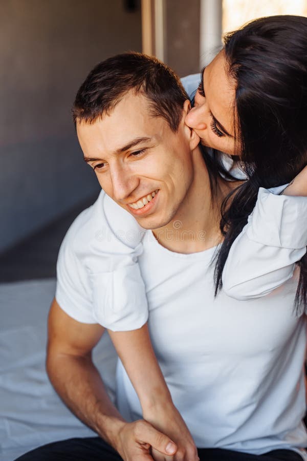 A Passionate Woman Hugging a Man Tenderly and Kissing Him Romantically