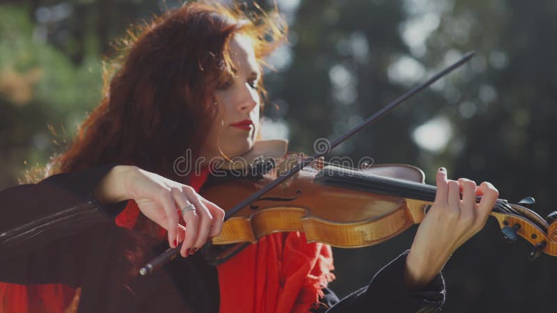 Passionate woman musician playing the violin