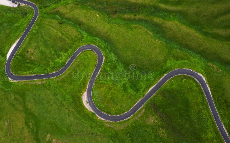 Passo di Giau Green hills Aerial drone shot of curved mountainous snake road. Traveling, transportation, safety driving, traveling