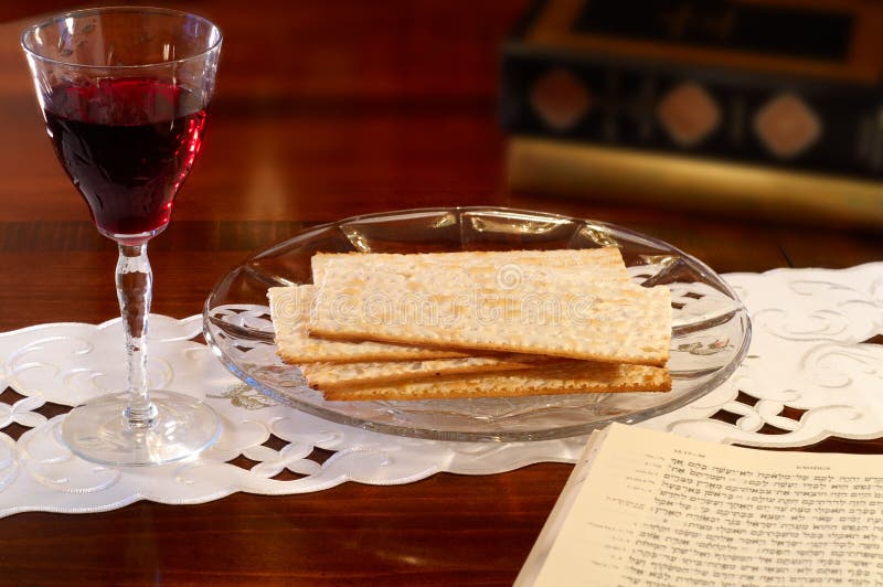 Passover elements of wine and matzoh on a table with Hebrew Old Testament open to the Passover passage in Exodus. Kosher stock images, royalty-free photos and pictures