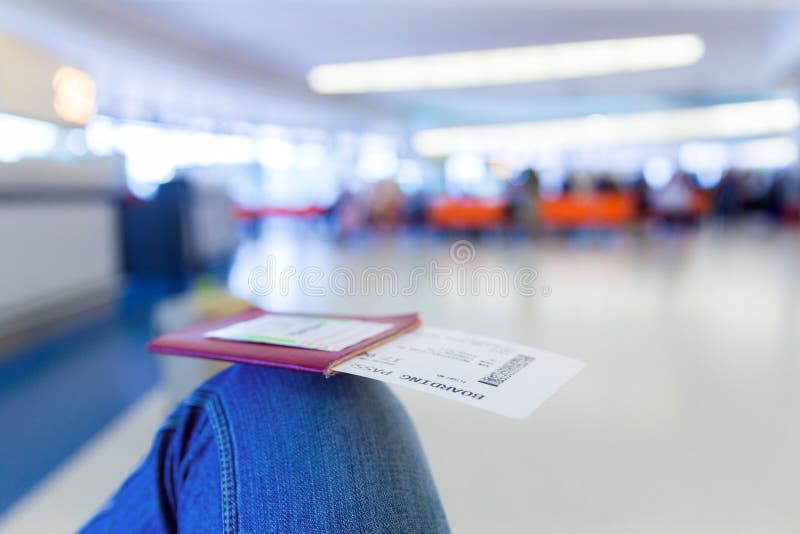 Passport with Boarding Pass at Departure Terminal Gate in Airport Stock