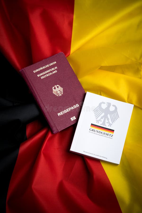 Passport and Constitution Basic Law Book of Germany on Flag Editorial