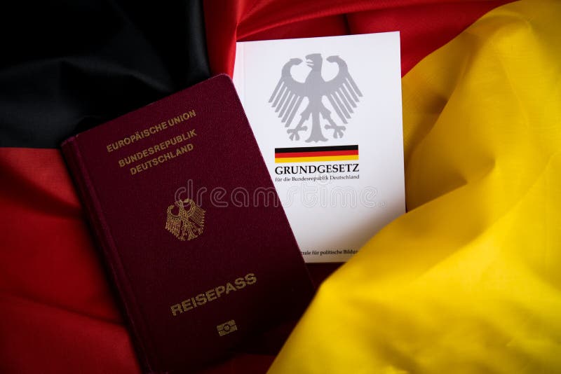 Passport and Constitution Basic Law Book of Germany on German Flag