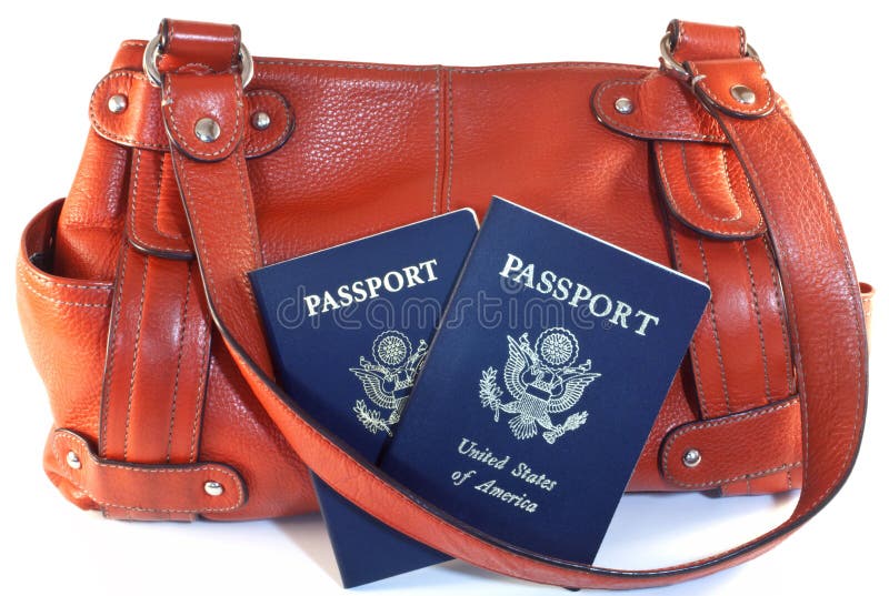 Two American passports with orange leather travel purse isolated on white background. Two American passports with orange leather travel purse isolated on white background.