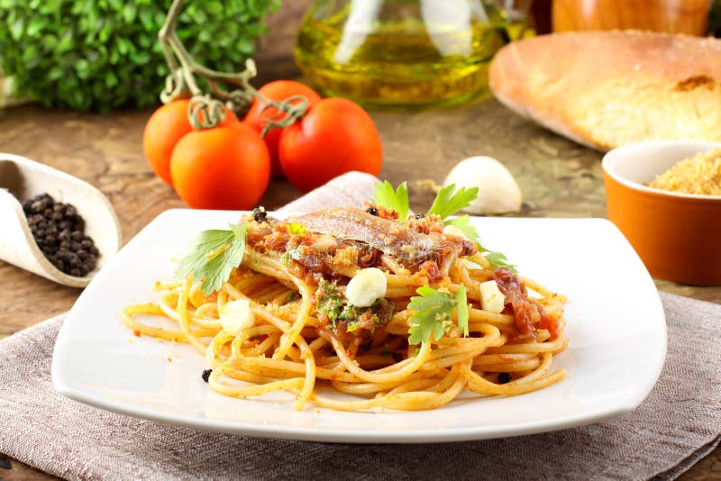 Pasta with anchovies, tomatoes royalty free stock images