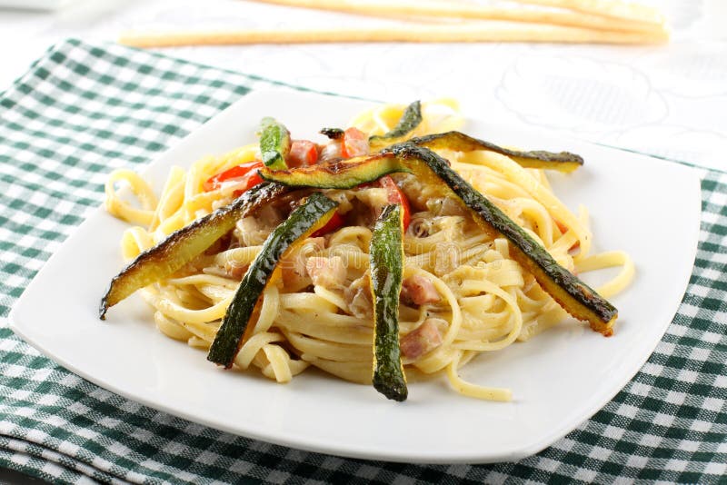 Pasta carbonara with fresh zucchini stock photo