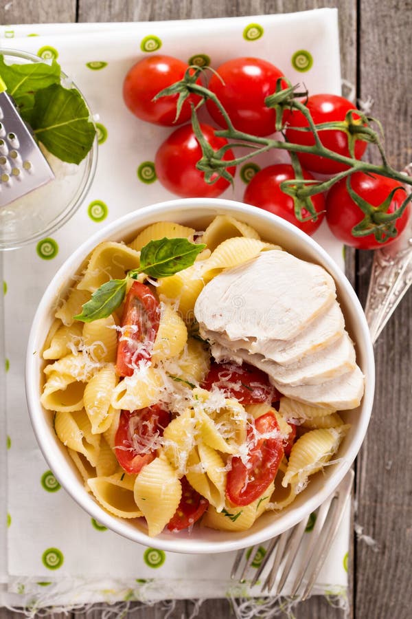 Pasta with cheese and cherry tomatoes stock photos