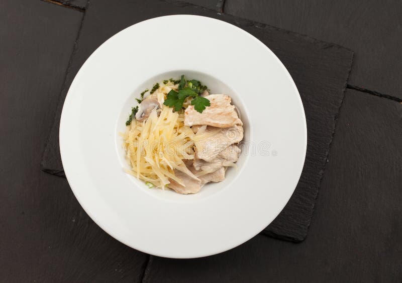Pasta with Chicken and Mushrooms in a Plate. View from Above Stock