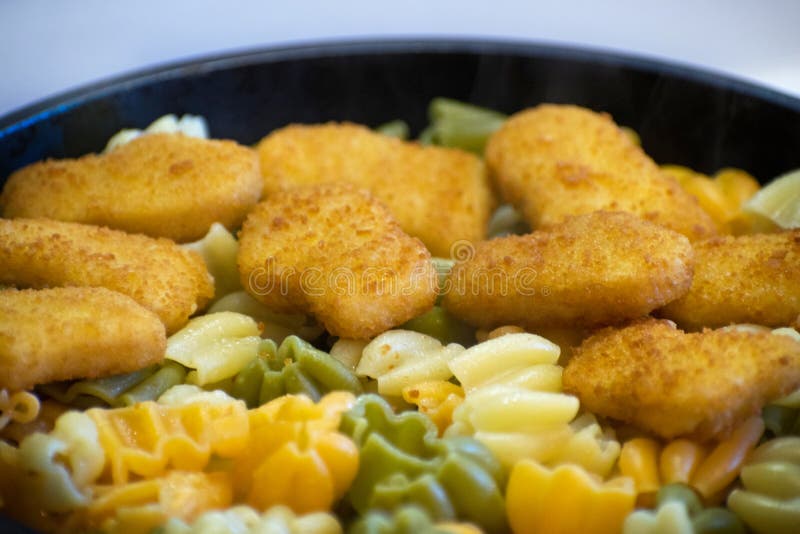 Pasta with Chicken Nuggets in a Frying Pan. Fried Chicken Nuggets ...